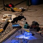 white electric guitar on blue guitar amplifier